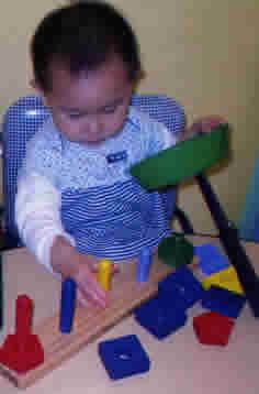 child playing with blocks at Woolly Mammoth Childcare & Pre-School